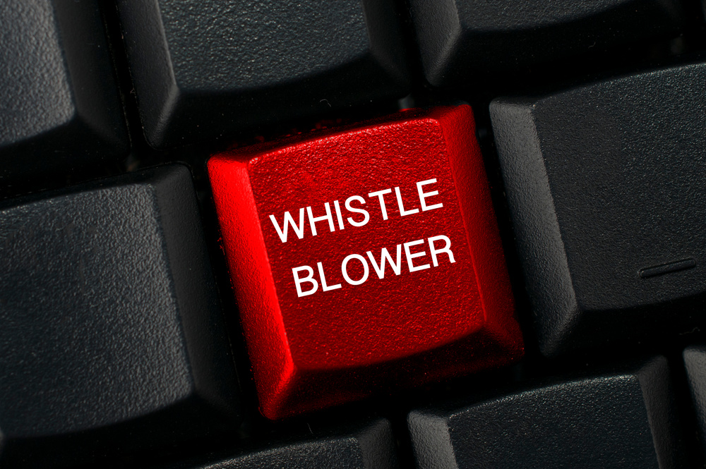 Whistleblowing concept: Black keyboard with a red key and the whistleblower word